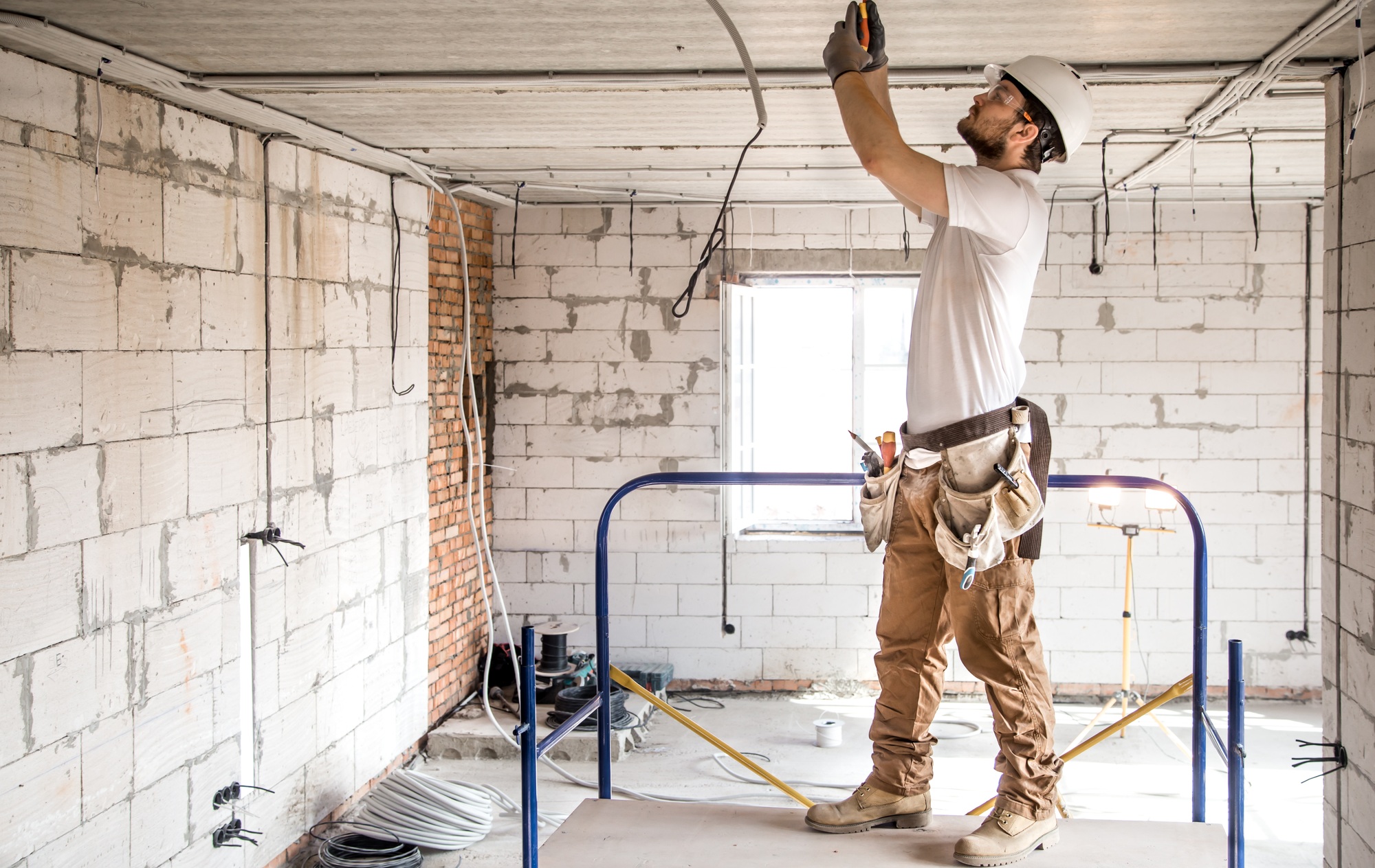Electrician working with cable on a construction site